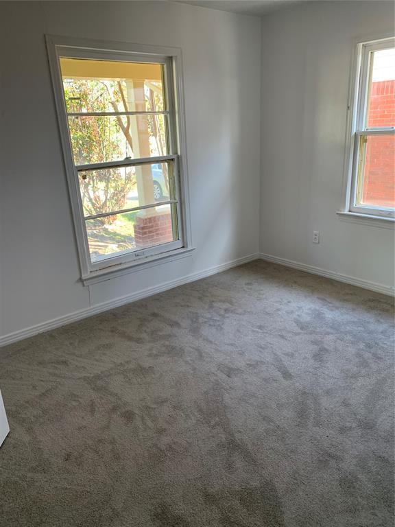 1006 N Market St, Shawnee, OK 74801 - carpeted empty room featuring baseboards
