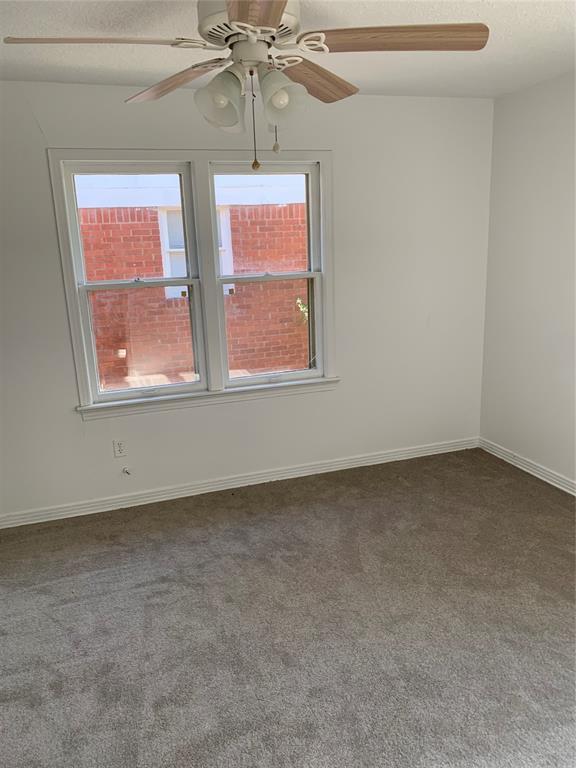 1006 N Market St, Shawnee, OK 74801 - empty room featuring carpet, baseboards, a ceiling fan, and a textured ceiling