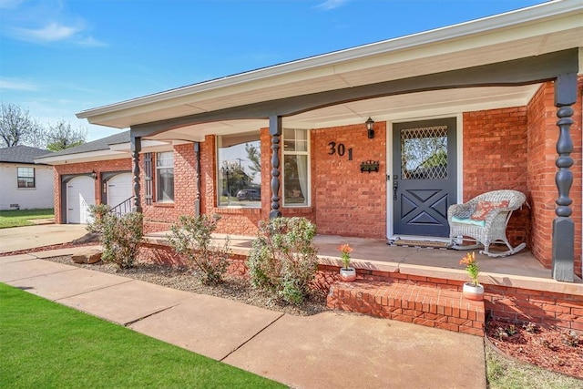view of front of property with brick siding, a porch, and driveway