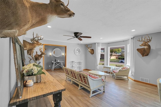 dining room featuring ceiling fan, visible vents, recessed lighting, light wood finished floors, and baseboards