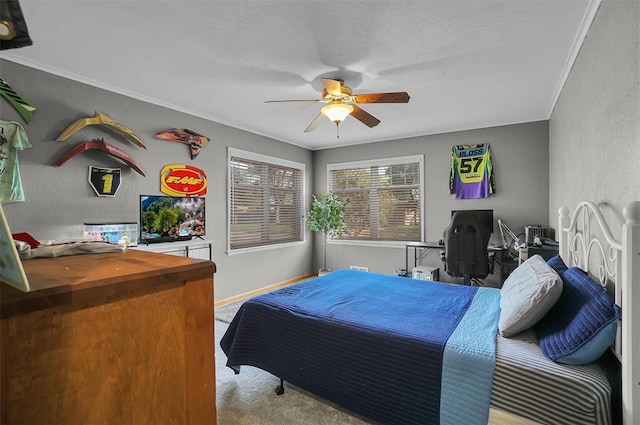 bedroom featuring carpet, baseboards, crown molding, and a ceiling fan