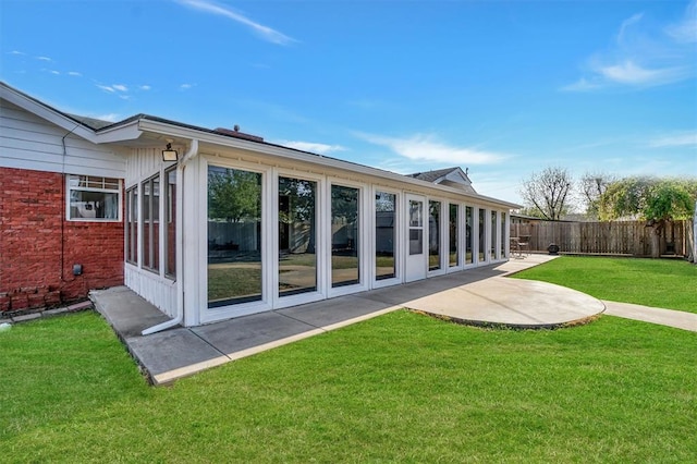 back of house with a patio area, fence, and a lawn