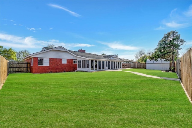 view of yard featuring a fenced backyard and a sunroom