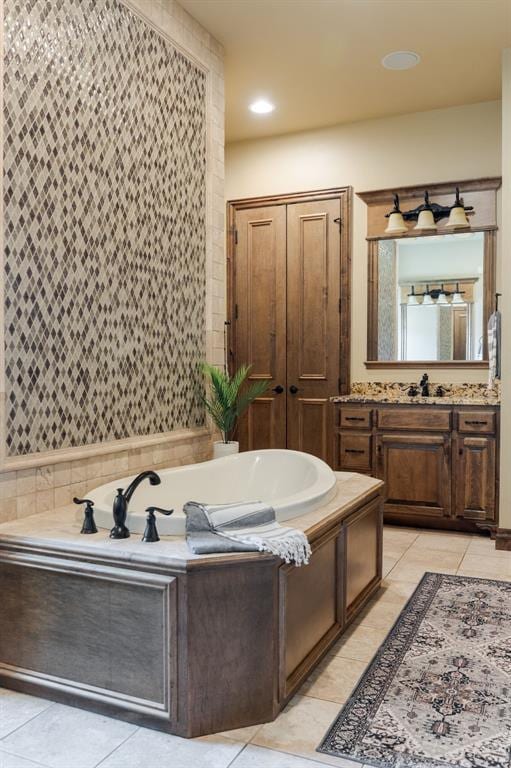 full bath featuring tile patterned floors, vanity, and a garden tub