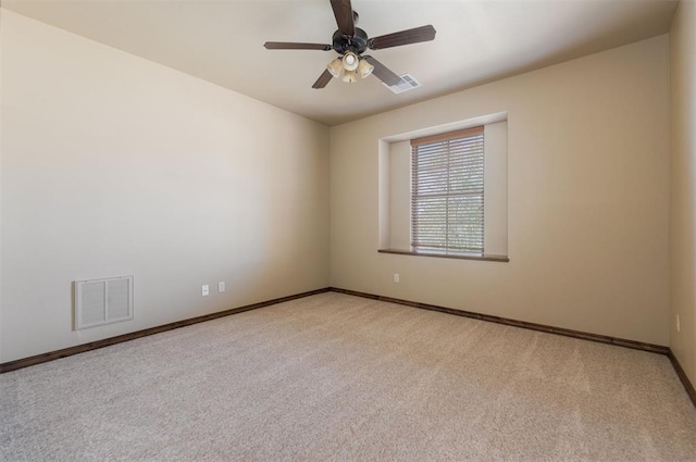 empty room featuring visible vents, baseboards, a ceiling fan, and carpet flooring