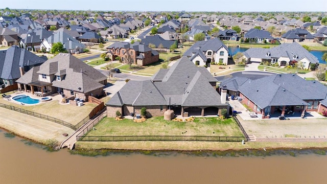 drone / aerial view with a residential view and a water view