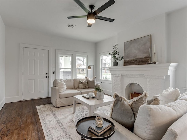 2431 NW 13th St, Oklahoma City, OK 73107 - living room with ceiling fan, dark wood-type flooring, and a fireplace