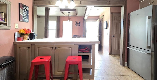 17904 Kings Rd, Shawnee, OK 74801 - kitchen featuring freestanding refrigerator, plenty of natural light, light countertops, and a peninsula