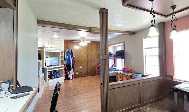 17904 Kings Rd, Shawnee, OK 74801 - interior space featuring wood finished floors, a textured ceiling, a ceiling fan, and wooden walls