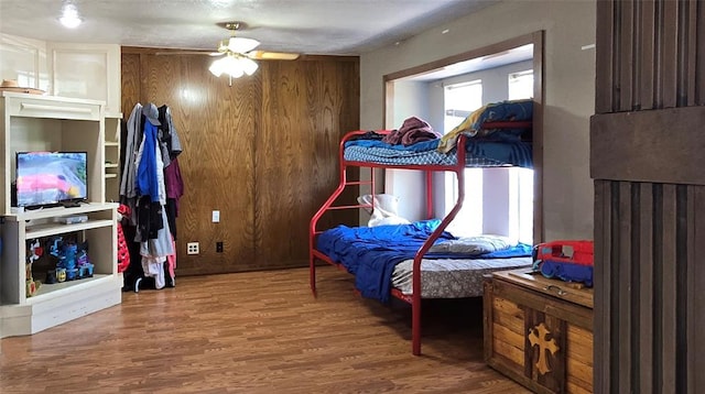 17904 Kings Rd, Shawnee, OK 74801 - bedroom with wood finished floors, a ceiling fan, and wood walls