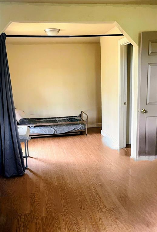 17904 Kings Rd, Shawnee, OK 74801 - unfurnished bedroom featuring wood finished floors and baseboards