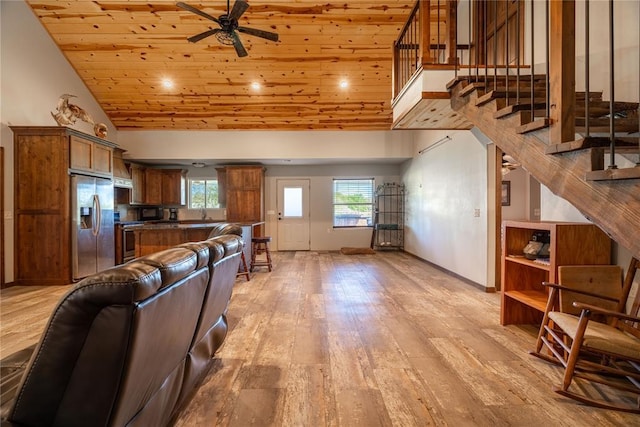4556 Cobra Ln, Kingston, OK 73439 - living room with light wood-style flooring, stairs, ceiling fan, high vaulted ceiling, and wood ceiling