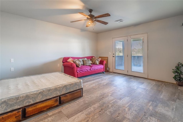 4556 Cobra Ln, Kingston, OK 73439 - bedroom featuring visible vents, access to outside, wood finished floors, and a ceiling fan