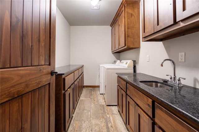 4556 Cobra Ln, Kingston, OK 73439 - washroom featuring baseboards, a sink, stone tile flooring, cabinet space, and washing machine and clothes dryer