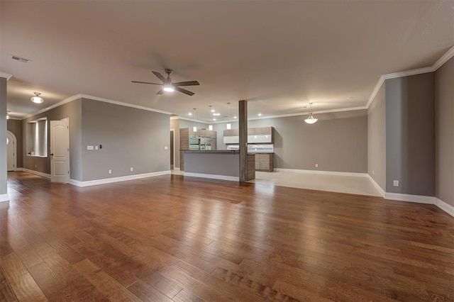 unfurnished living room with ceiling fan, ornamental molding, dark wood finished floors, and visible vents
