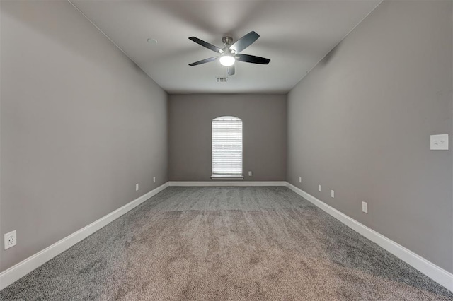 unfurnished room featuring baseboards, ceiling fan, and light carpet