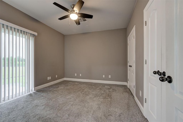 carpeted empty room featuring a ceiling fan, baseboards, and visible vents