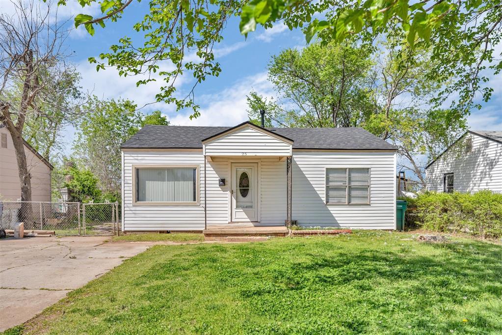25 SW 56th St, Oklahoma City, OK 73109 - bungalow featuring a front yard, fence, a gate, and roof with shingles