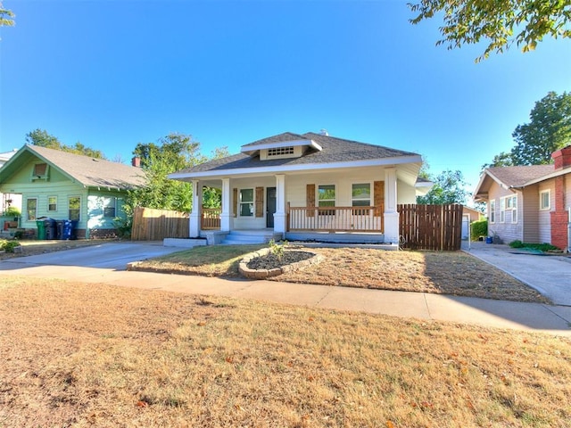 bungalow with a porch and fence