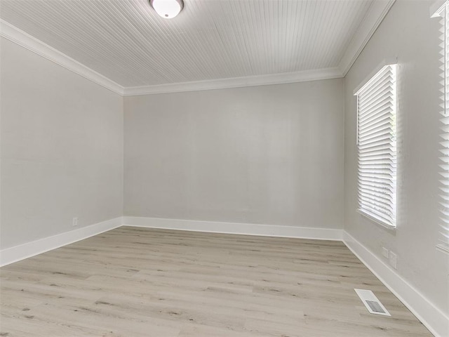 unfurnished room with light wood-style floors, a healthy amount of sunlight, ornamental molding, and visible vents