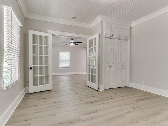 unfurnished room featuring light wood-type flooring, french doors, baseboards, and ornamental molding