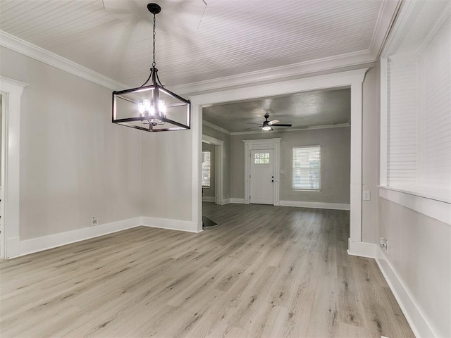 unfurnished dining area with ornamental molding, baseboards, light wood-type flooring, and ceiling fan with notable chandelier