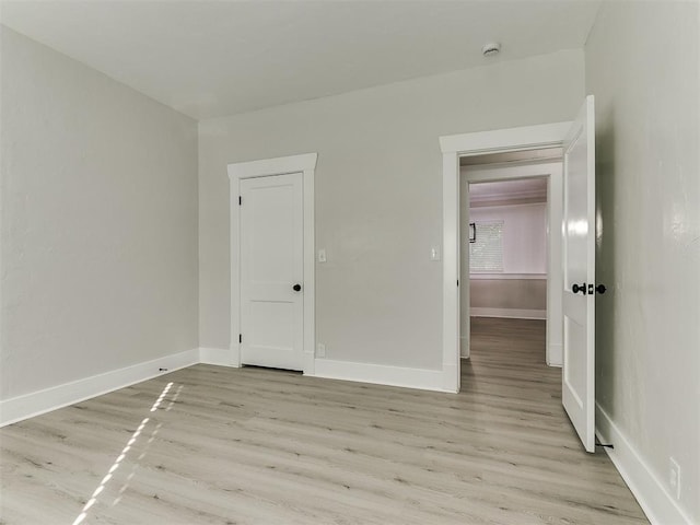 unfurnished bedroom featuring light wood-style floors and baseboards