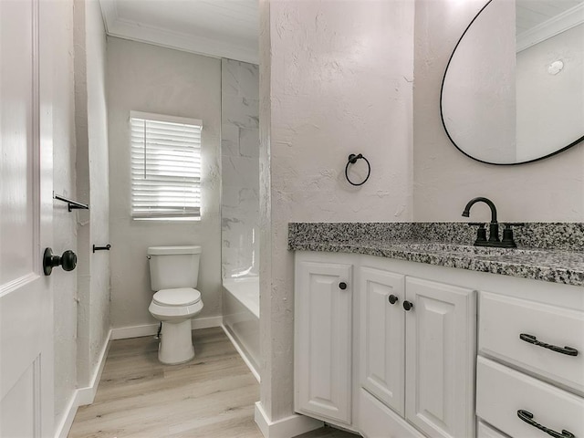 bathroom featuring vanity, baseboards, crown molding, toilet, and wood finished floors