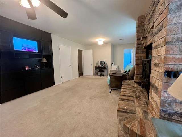 136 Skyline Dr, Chickasha, OK 73018 - carpeted living room with visible vents, ceiling fan, and a brick fireplace