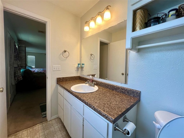 136 Skyline Dr, Chickasha, OK 73018 - ensuite bathroom featuring visible vents, toilet, ensuite bath, vanity, and tile patterned floors