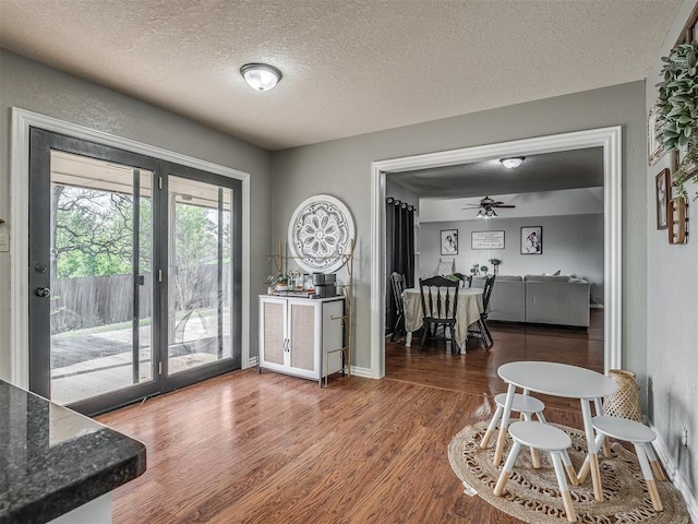 7 Kaross Dr, Shawnee, OK 74801 - dining room featuring a textured ceiling, wood finished floors, and ceiling fan