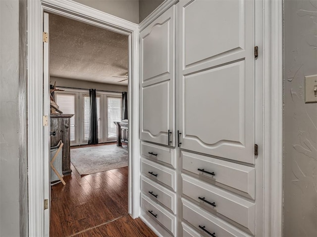 7 Kaross Dr, Shawnee, OK 74801 - hall featuring dark wood-style floors and a textured ceiling
