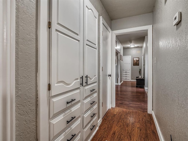 7 Kaross Dr, Shawnee, OK 74801 - hall featuring a textured wall and dark wood finished floors