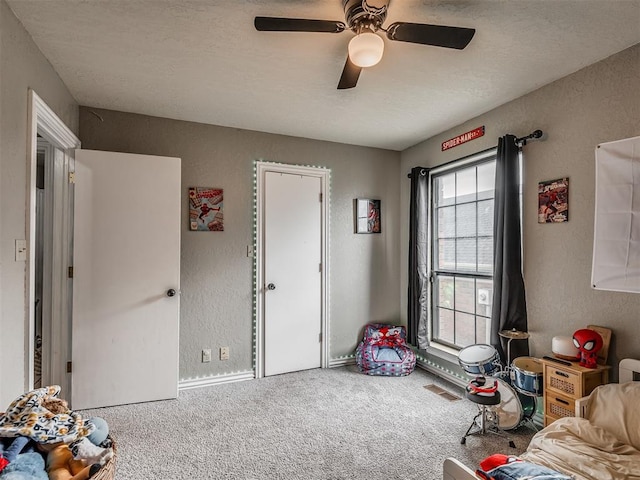 7 Kaross Dr, Shawnee, OK 74801 - carpeted bedroom featuring a textured wall and a ceiling fan