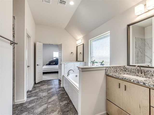 ensuite bathroom with vanity, ensuite bathroom, lofted ceiling, and visible vents