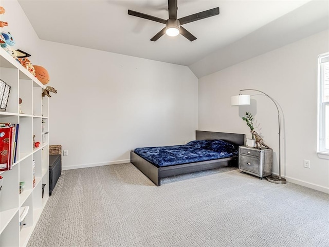 carpeted bedroom with multiple windows, baseboards, a ceiling fan, and lofted ceiling