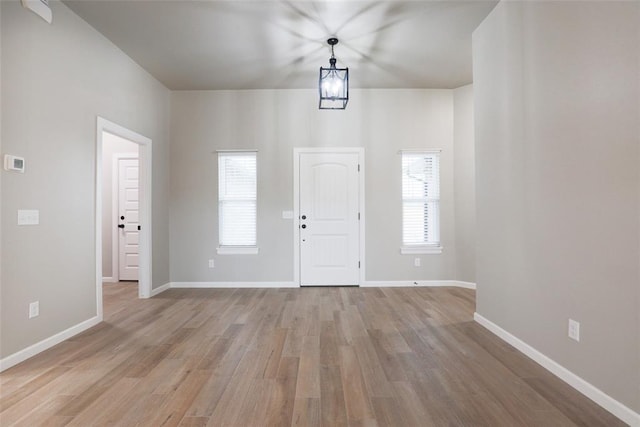 entrance foyer featuring baseboards and light wood-style floors
