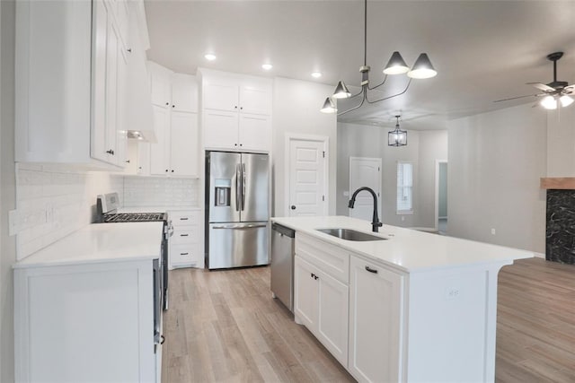 kitchen featuring light countertops, light wood-style floors, a sink, and stainless steel appliances