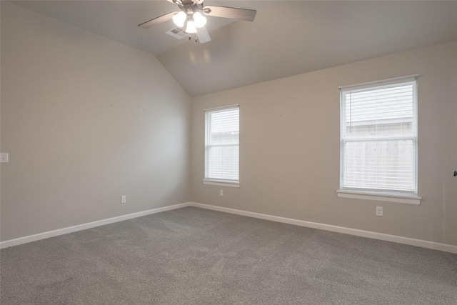 unfurnished room with baseboards, a ceiling fan, vaulted ceiling, and carpet floors
