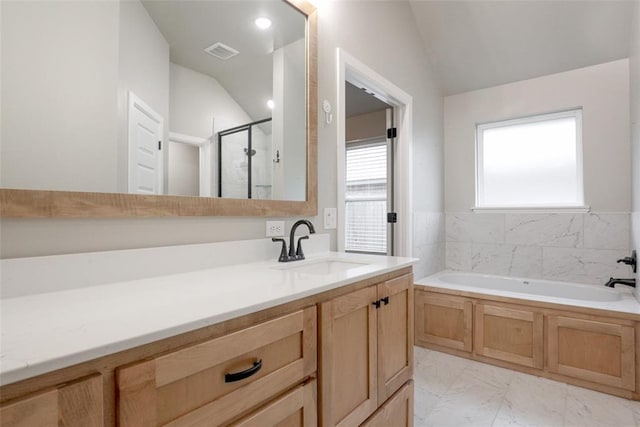 bathroom with a garden tub, visible vents, vaulted ceiling, and a stall shower