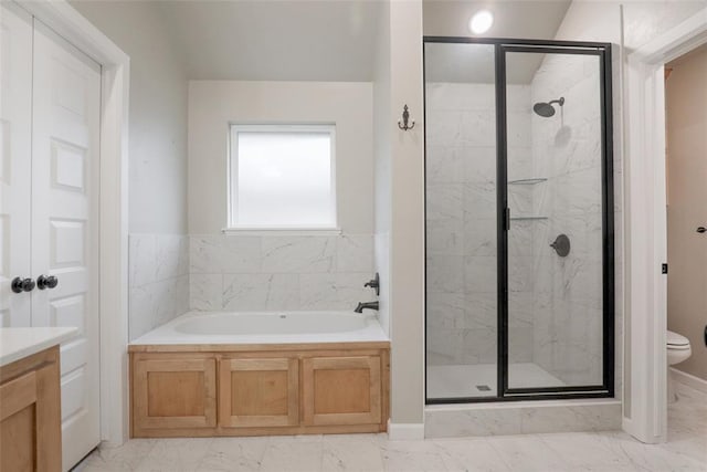 full bath with a bath, toilet, vanity, a marble finish shower, and marble finish floor