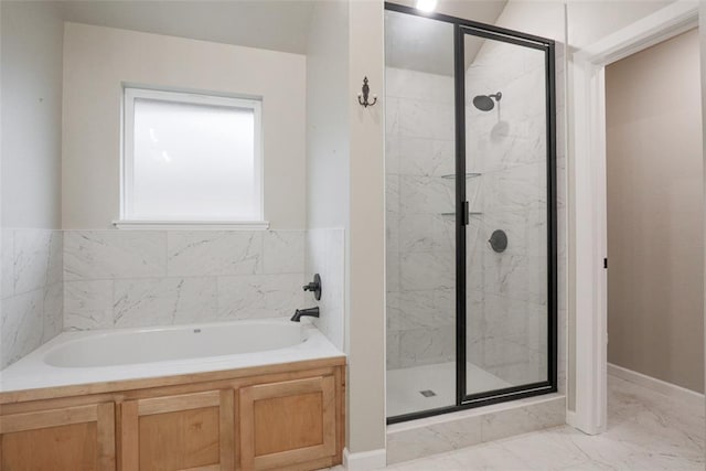 full bathroom featuring a bath, a shower stall, marble finish floor, and baseboards