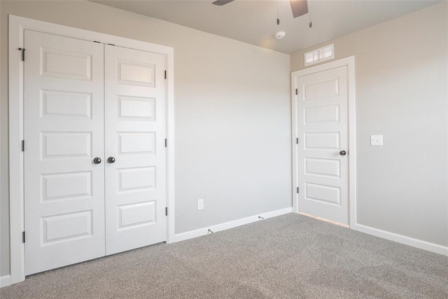 spare room featuring baseboards, a ceiling fan, and carpet floors