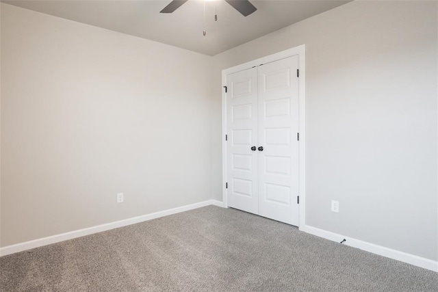 empty room featuring carpet floors, baseboards, and a ceiling fan