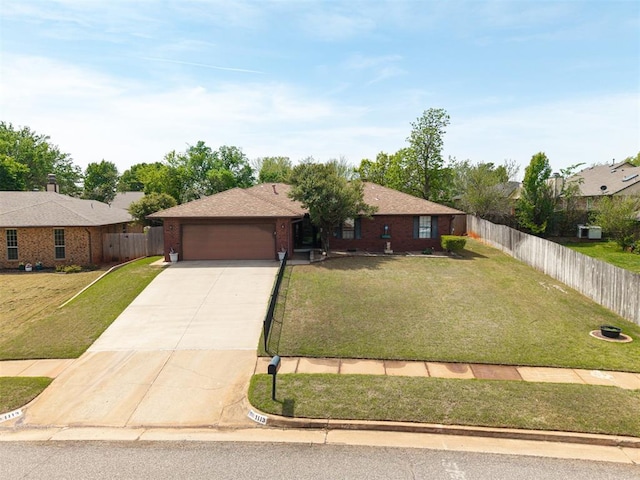 1113 Bank Side Cir, Edmond, OK 73012 - ranch-style house with a garage, a front lawn, concrete driveway, and fence