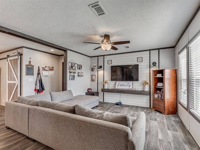 28737 Oakwood Meadows Dr, Cashion, OK 73016 - living area with visible vents, wood finished floors, and a textured ceiling