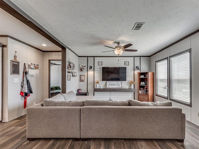 28737 Oakwood Meadows Dr, Cashion, OK 73016 - living area featuring visible vents, dark wood-style flooring, ornamental molding, and ceiling fan