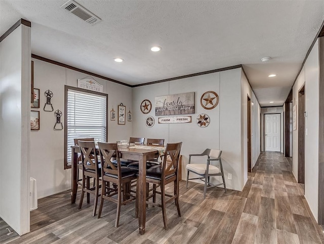 28737 Oakwood Meadows Dr, Cashion, OK 73016 - dining room with a textured ceiling, wood finished floors, visible vents, and recessed lighting