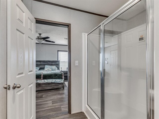 28737 Oakwood Meadows Dr, Cashion, OK 73016 - full bathroom featuring ceiling fan, a shower stall, ensuite bath, ornamental molding, and wood finished floors