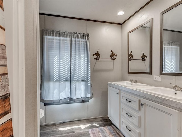 28737 Oakwood Meadows Dr, Cashion, OK 73016 - full bath featuring toilet, wood finished floors, double vanity, and a sink